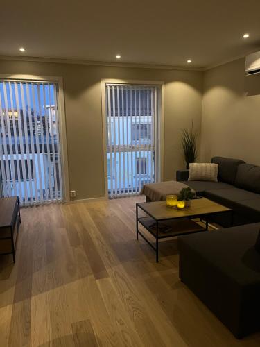 a living room with a couch and a table at ROOF HOUSE, Downtown in Sandefjord in Sandefjord
