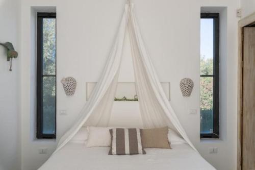 Postel nebo postele na pokoji v ubytování Villa Aura d`Olivo by Perle di Puglia