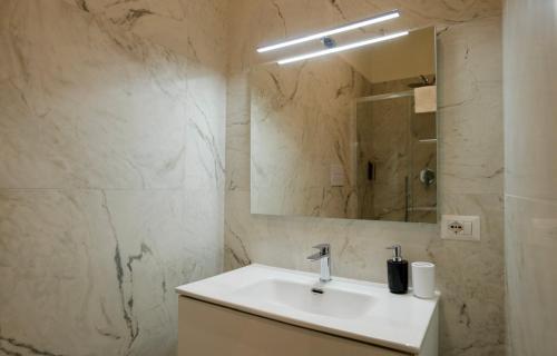 a bathroom with a sink and a mirror at Relais Vittorio Veneto - Luxotel & Apartotel in Salerno