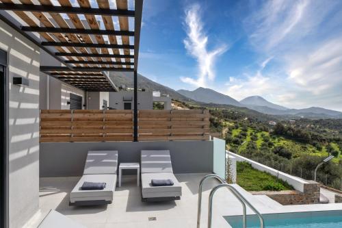 a villa with a view of the mountains at Villa April, Seaview and pool in Marioú