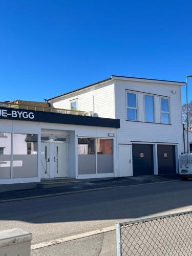 a white building with a bike garage on a street at ROOF HOUSE, Downtown in Sandefjord in Sandefjord