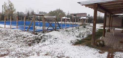 a swimming pool with snow on the ground at Cabañas Las Bahienses in San Rafael