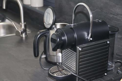a black coffee maker sitting on a counter at Ferienwohnung Sperlich Quartier in Bad Berleburg