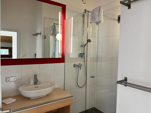 a bathroom with a sink and a shower at Lake Resort Pressegger See in Hermagor