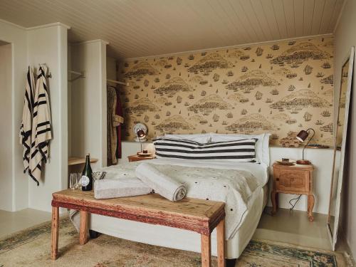a bedroom with a bed and a wooden table at Buena Vista in Struisbaai in Struisbaai