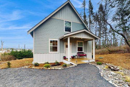 a small house with a porch and a driveway at Heron's Landing in Lummi Island