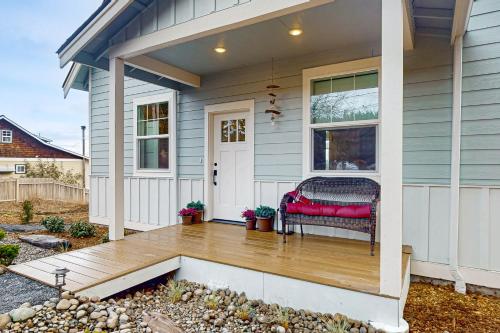 a front porch of a house with a red bench at Heron's Landing in Lummi Island