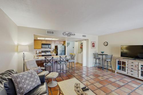 a living room and kitchen with a couch and a table at Quiet Serenity Retreat in Tucson