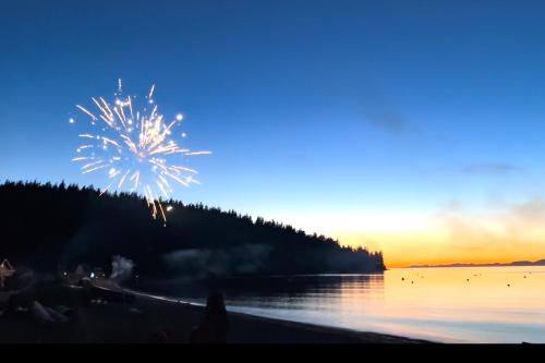 a firework display on the beach at sunset at Heron's Landing in Lummi Island