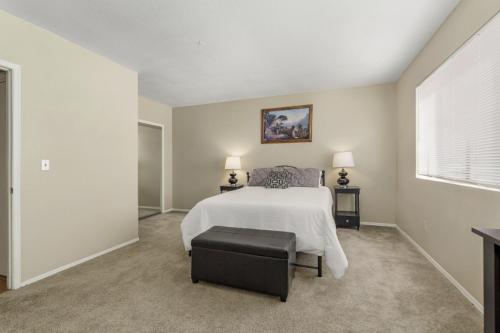 a bedroom with a white bed and a window at Quiet Serenity Retreat in Tucson