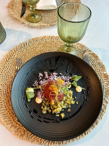 a black plate of food on a table at Kamienica Boutique ApartHotel in Białystok