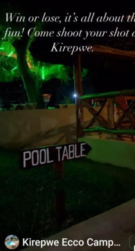 a sign with a pole with a green light at Kirepwe Ecco Camp Watamu in Watamu