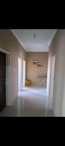 an empty room with a table in the middle of it at Edmut apartments in Lusaka