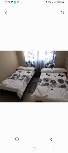 a small room with two beds in it at Edmut apartments in Lusaka