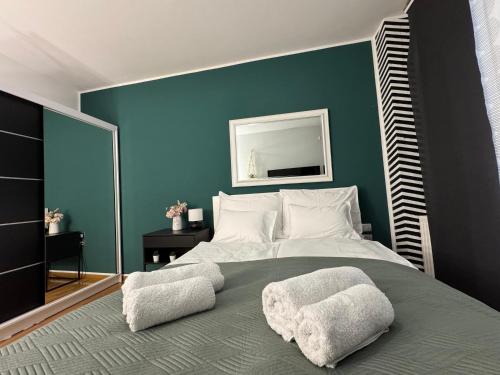 a bedroom with a large bed with two pillows on it at Titanium in Izola