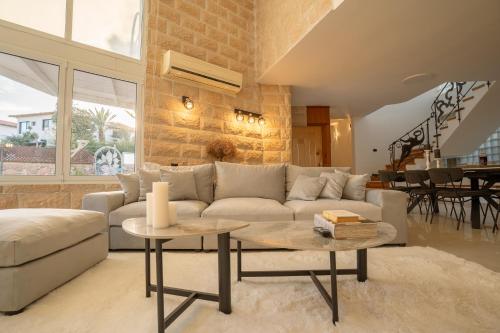 a living room with a couch and a table at Villa Yuka- Luxurious Villa in Eilat