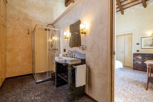 a bathroom with a sink and a shower and a mirror at Palazzo Remer - luxury apartments - by Bricola Apartments in Venice