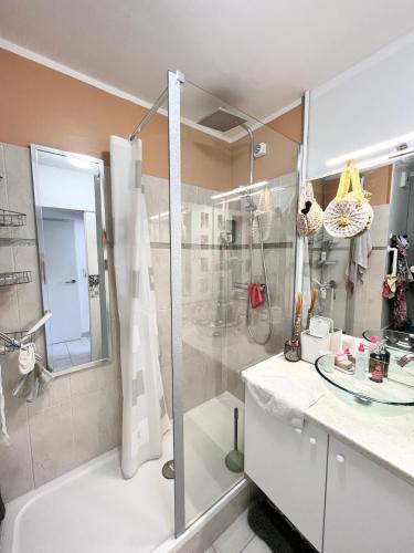 une salle de bain avec douche et lavabo dans l'établissement CHEZ MONNA confort , résidence avec piscine, à La Ciotat