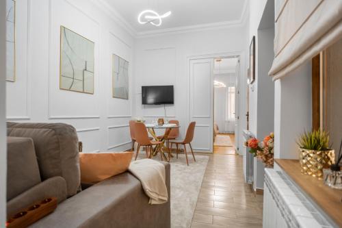 a living room with a couch and a table at Central Luxury Apartments with Private Garden & Parking in Bucharest
