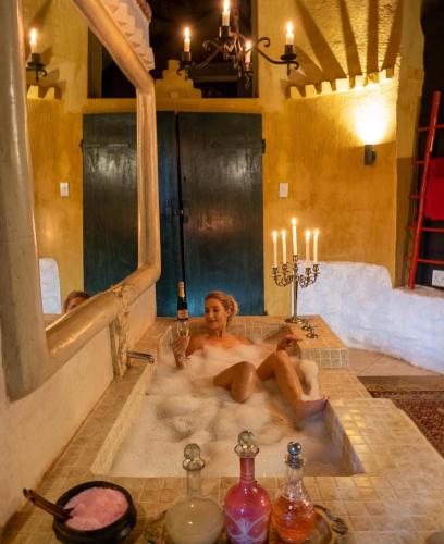 a couple of people sitting in a bath tub at Timamoon Lodge in Hazyview