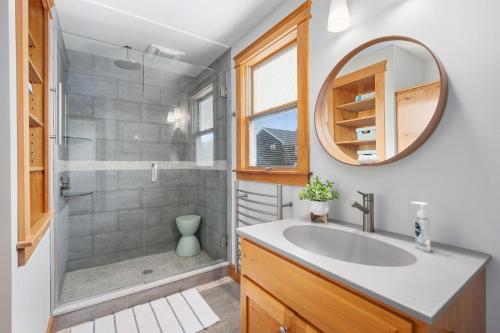 a bathroom with a sink and a shower with a mirror at 57 Wood Avenue Sandwich - - Cape Cod in Sandwich