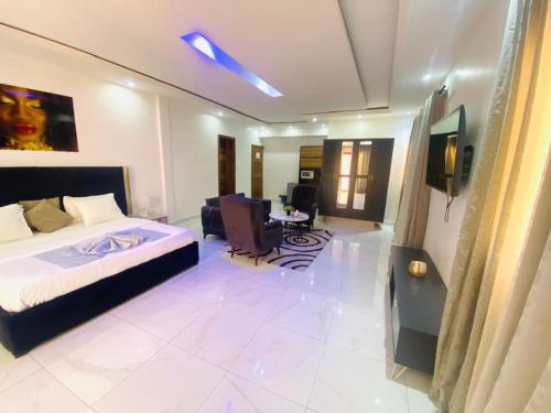 a bedroom with a bed and a living room at Bi-Hotel 1 in Dakar
