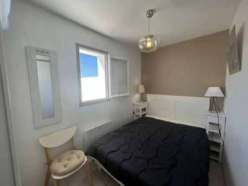 une chambre avec un lit noir et une fenêtre dans l'établissement Appartement 2 pièces avec balcon et parking privé - FR-1-224B-71, à Noirmoutier-en-l'lle