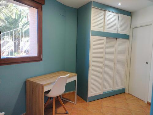 a room with a desk and a chair and a window at Apartamentos Montgò in Denia