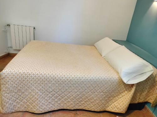 a bedroom with a bed with a pillow on it at Apartamentos Montgò in Denia