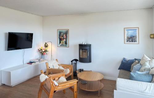 a living room with a couch and a table at Lovely Home In Samsø With Kitchen in Tanderup