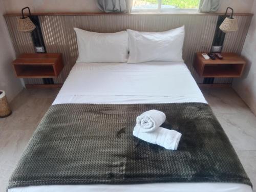 a hotel room with a bed with a towel on it at Apart MCKELLER in Cueva de Morgan