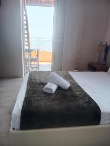 a hotel room with a bed with a towel on it at Apart MCKELLER in Cueva de Morgan