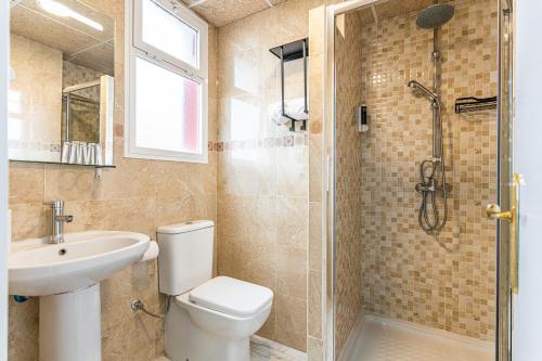 a bathroom with a toilet and a sink and a shower at Hotel Mexico in Madrid