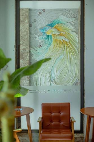a painting of a peacock on the wall in a room at Sunrise Valley Dalat Hotel in Da Lat
