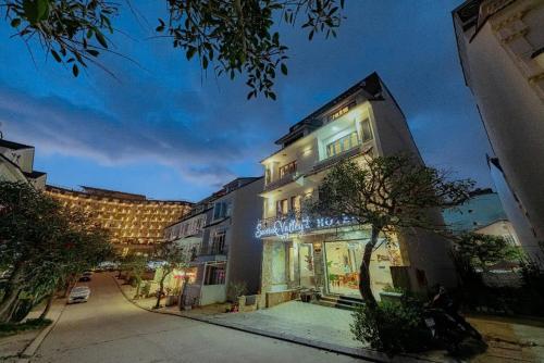 a building with lights on the side of it at Sunrise Valley Dalat Hotel in Da Lat