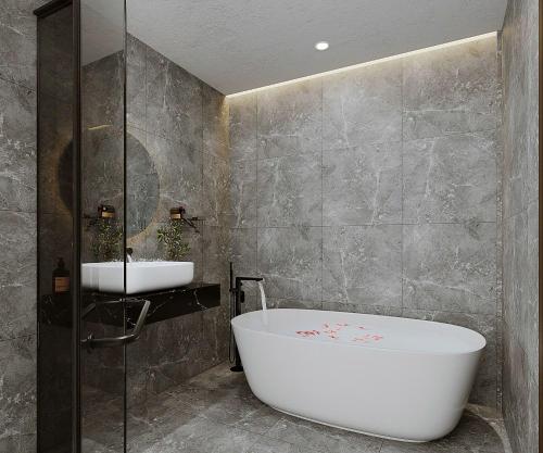 a bathroom with a bath tub and a sink at Sunrise Mountain View Resort in Vang Vieng