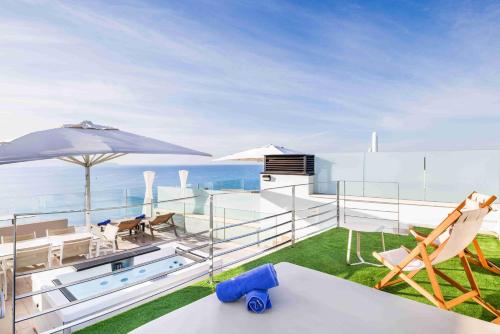 a house with a balcony with a view of the ocean at Aparthotel Fontanellas Playa in Playa de Palma