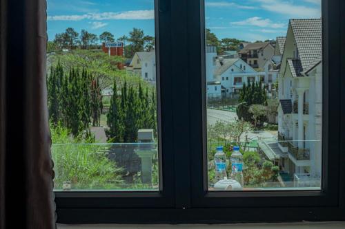 two soda bottles sitting on a window sill at Sunrise Valley Dalat Hotel in Da Lat
