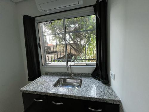 a sink in a kitchen with a window at Condomínio Residencial Vitória 3 in Sao Paulo