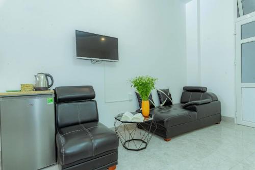 a living room with a couch and a chair at Sunrise Valley Dalat Hotel in Da Lat