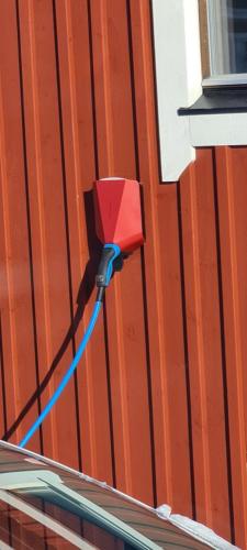 a red object is attached to the side of a building at Aurora Jukkas Riverside Lodge in Jukkasjärvi