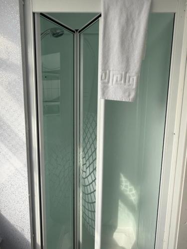 a glass shower stall with a towel on it at The Aberford in Blackpool