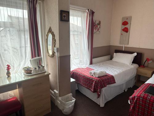 a small bedroom with a bed and a window at The Aberford in Blackpool
