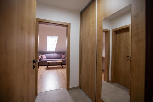 a hallway with a purple couch in a room at Apartmány Hvezdáreň in Spišská Nová Ves