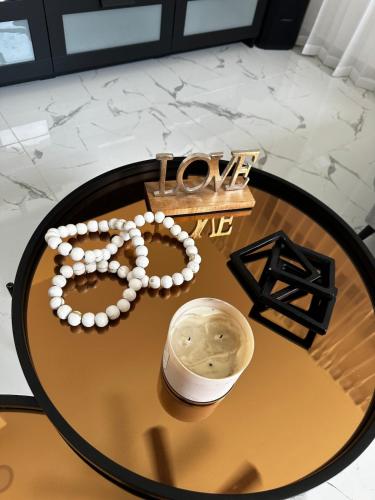 a table with a necklace and a watch on it at Stunning Brand New Villa in Downtown Punta Cana in Punta Cana