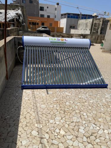 a blue bench sitting on top of a sidewalk at Résidence d hôtes Minerva Mermoz in Dakar