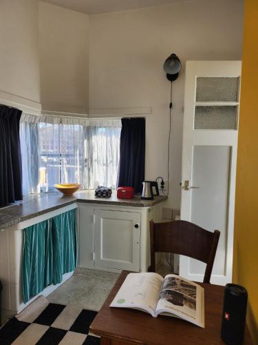 a kitchen with a table with an open book on it at SWEETS - Kattenslootbrug in Amsterdam