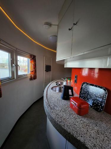 a kitchen with a sink and a counter at SWEETS - Kortjewantsbrug in Amsterdam