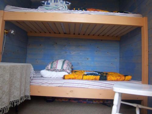 a bunk bed with two pillows on top of it at Änggårde B&B in Huse