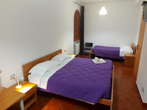 Postel nebo postele na pokoji v ubytování Villa Le Arcate